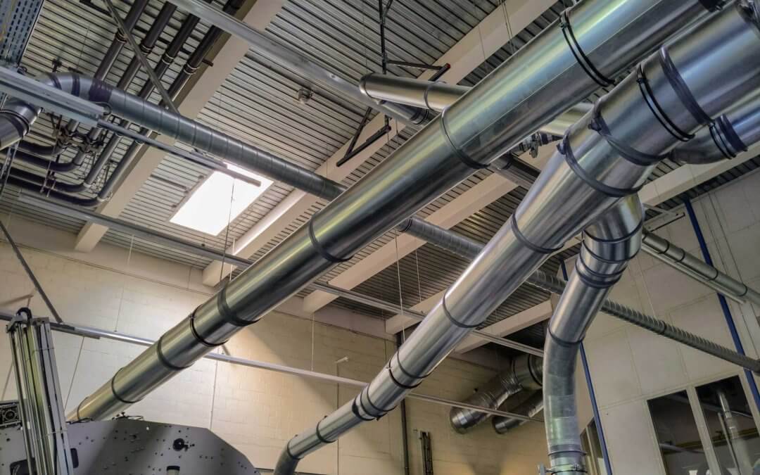 Dust and paper trimming collection ducts at the end of a printing press